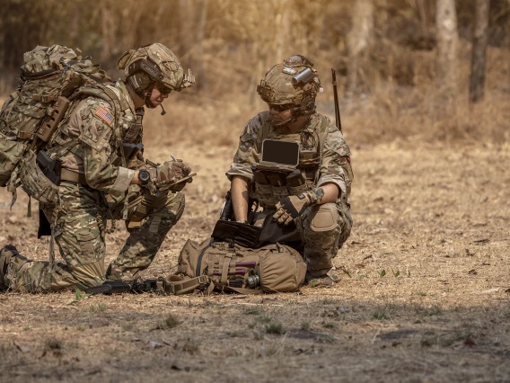 Soldiers crouching down and communicating