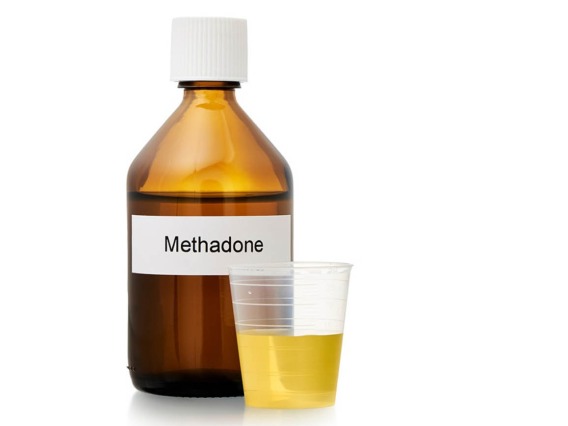 brown bottle labeled methadone with small dose cup