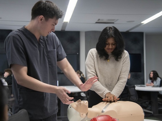 University of Arizona College of Medicine – Phoenix student James Bates teaches high school student Maalavika Menon how to do CPR.