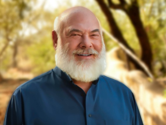Portrait of Dr Andrew Weil, wearing a blue shirt in an outdoor setting
