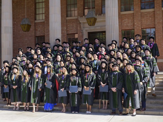 Group portraint of medical students from the College of Medicine – Tucson class of 2023 on the steps in front of a building.