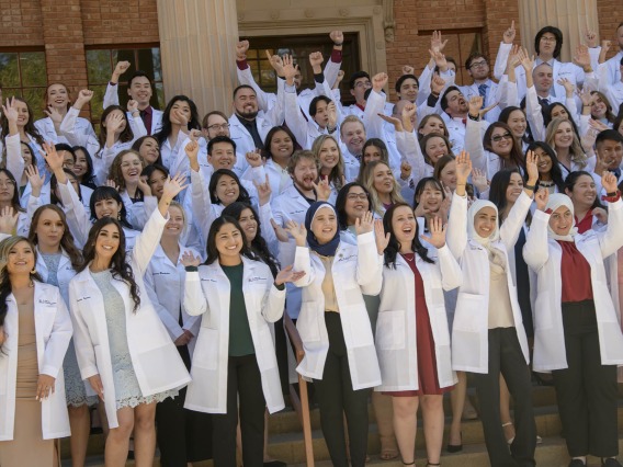 The R. Ken Coit College of Pharmacy class of 2023 cheers as they prepare to have their class photo taken after their white coat ceremony at Centennial Hall. 