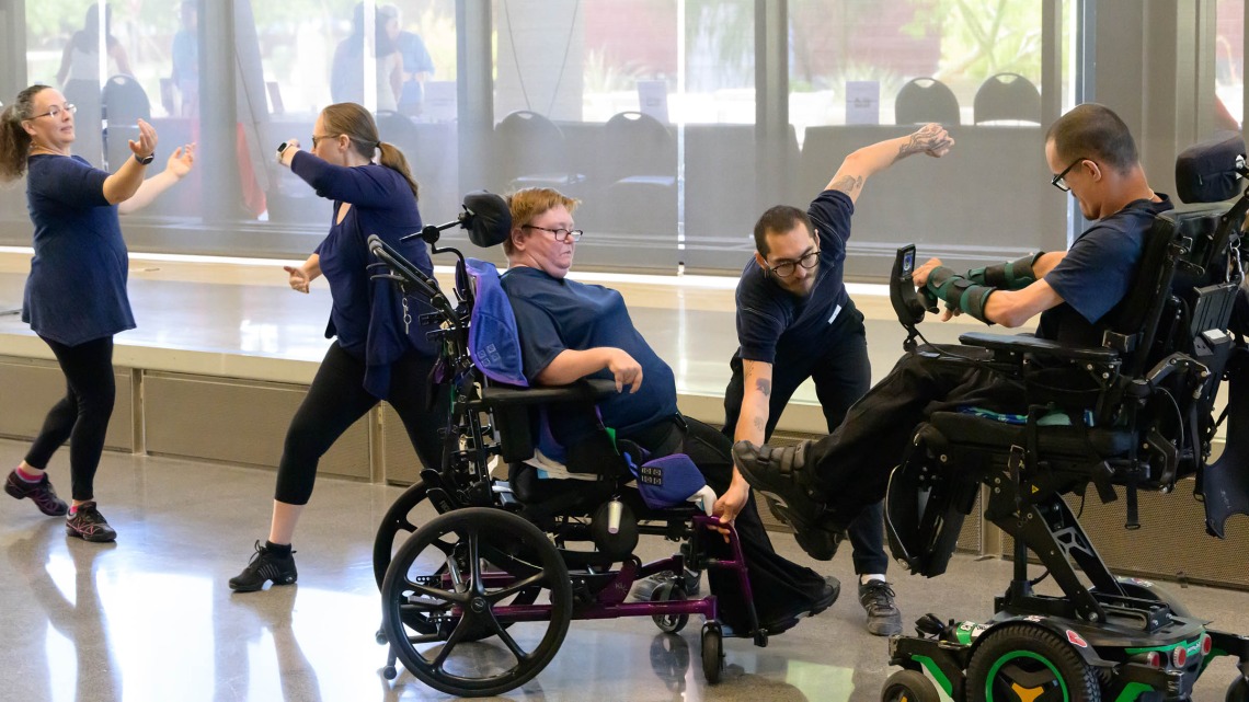 A group of dancers, two in wheelchairs, perform an interpritive dance. 