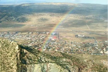 An aerial view from a small airplane with a rainbow 