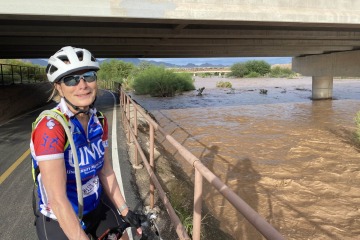Kathleen Insel poses with her bicycle on one of Tucson’s bike paths