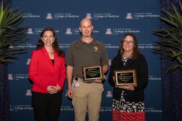 Three smiling College of Medicine – Tucson faculty members pose for a photo after two of them received awards. 