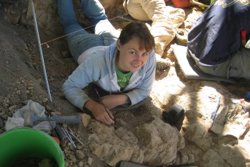 Halszka Glowacka lies on the ground beneath a tent looking for fossils in a photo from 2006 when she was an undergraduate.