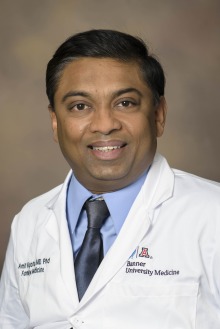 Portrait of Dr. Amit Algotar from the University of Arizona College of Medicine – Tucson wearing a white physician’s coat.